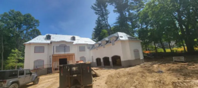 Large new stucco home with three-car garage under construction