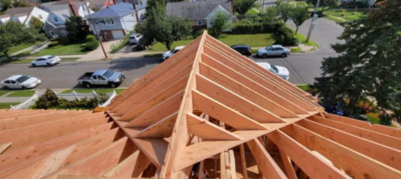 New hip roof rafters framed over a house, seen from above